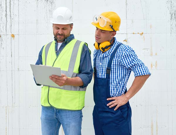 Construction Workers Discussing Building